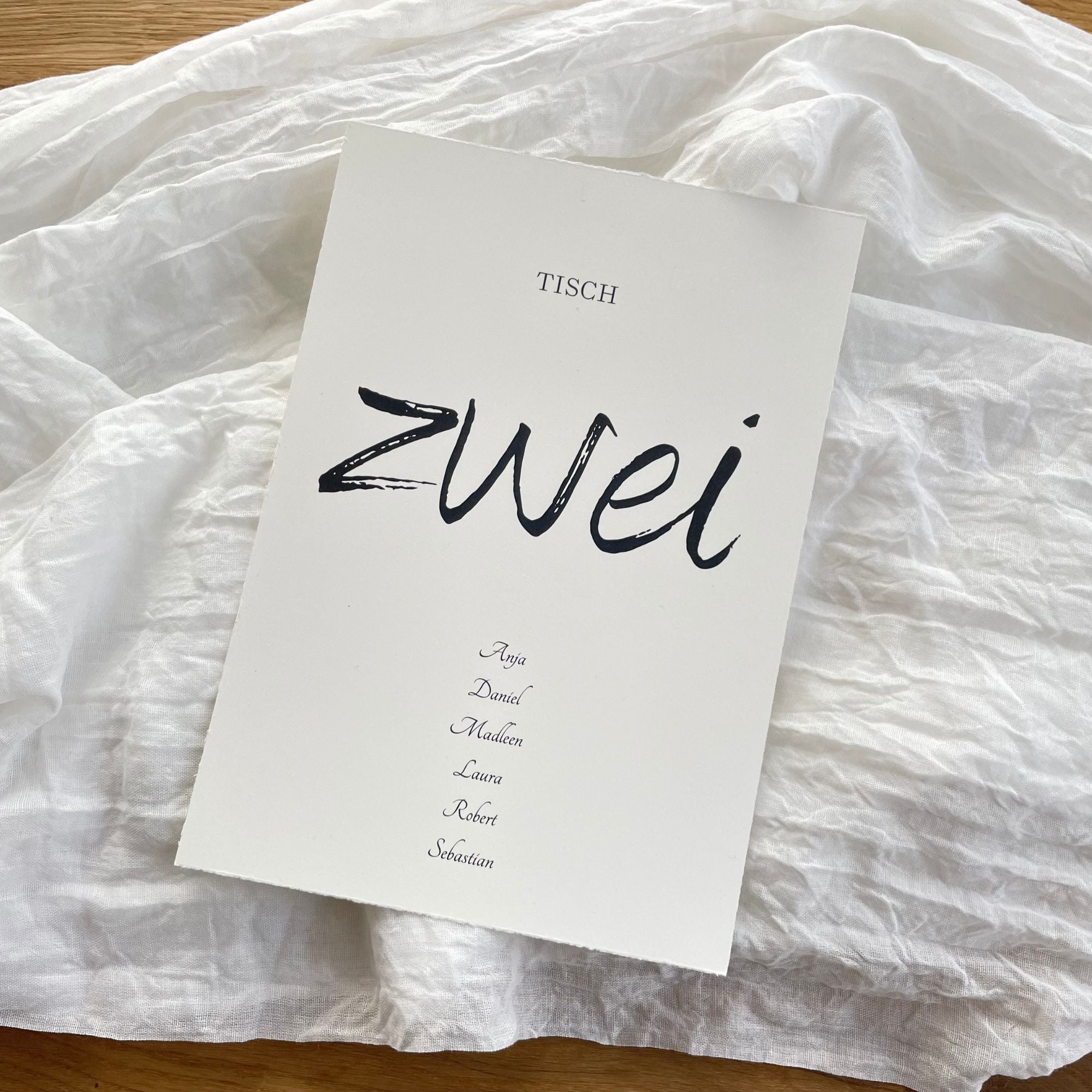 Elegante Tischnummern aus handgerissenem Büttenpapier in Altweiß